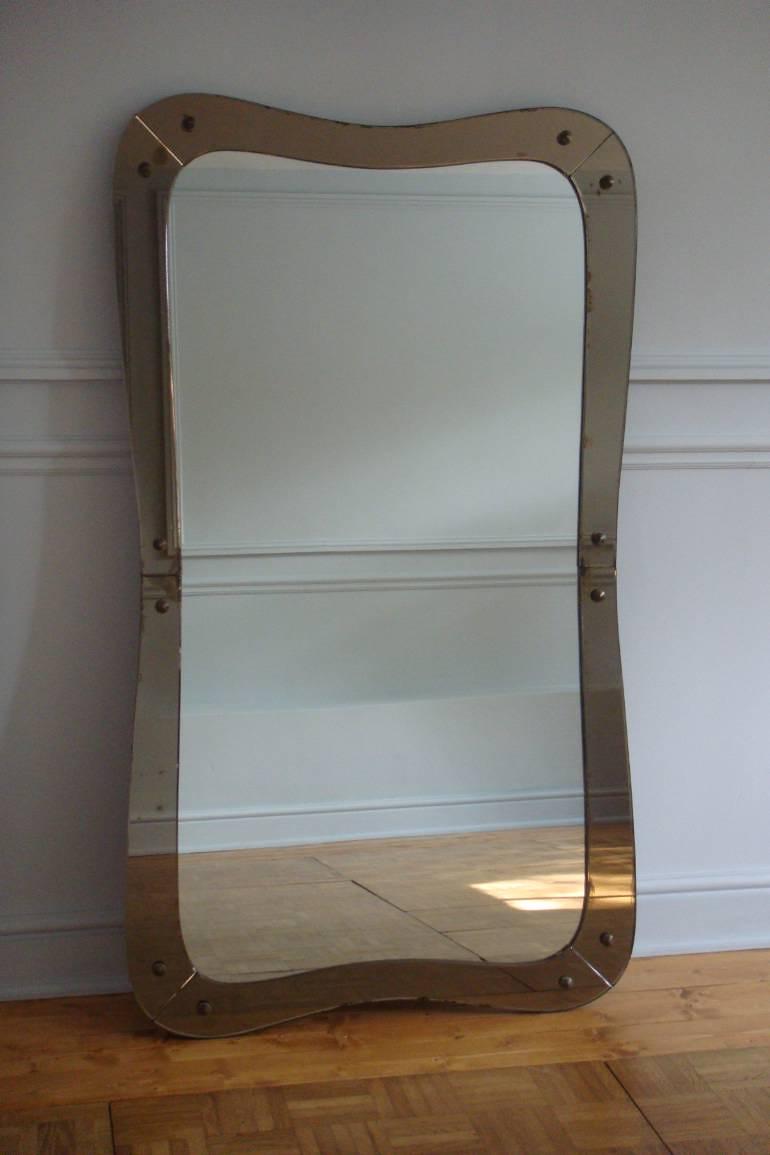 Elegantly shaped 1950`s Italian mirror with brown glass border. Original condition