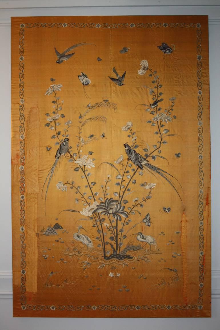 A yellow/gold hand embroidered silk panel