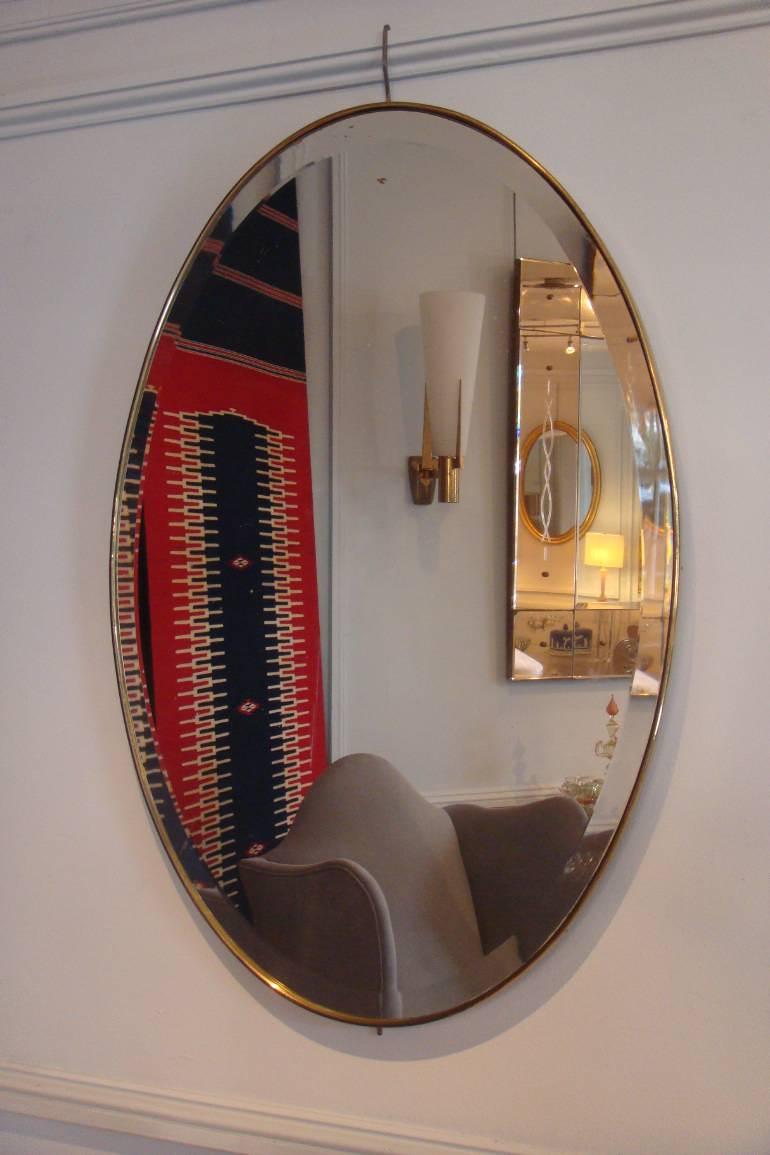 Simple and elegant oval gold metal banded bevelled glass mirror, Italian c1950
