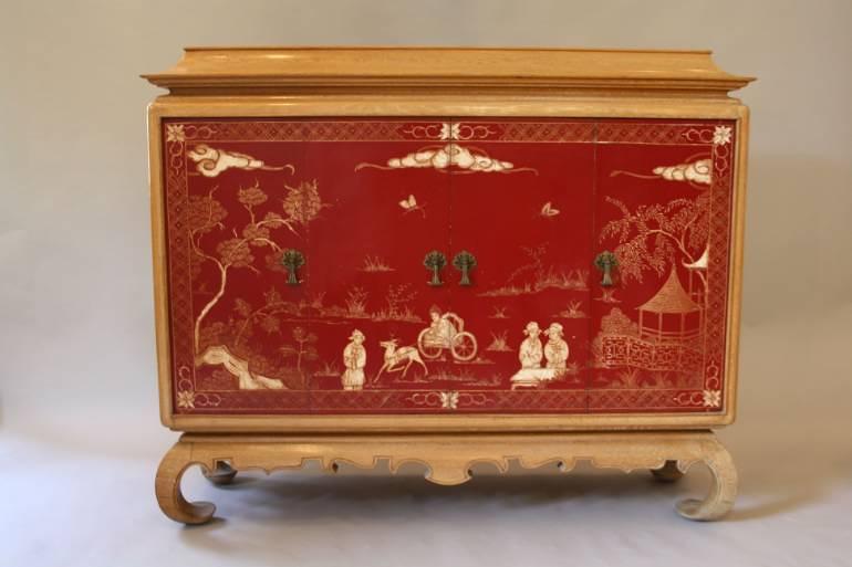 A pagoda Oak cabinet with carved doors depicting Chinese scenes, French c1940