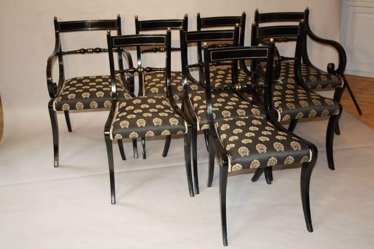 A set of eight brass and ebonised Regency dining chairs inc two carvers