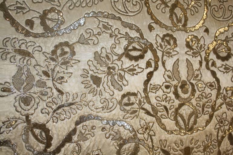 Indian hand stitched sequin textile of stylised flora and fauna on cream silk background. Early 20th