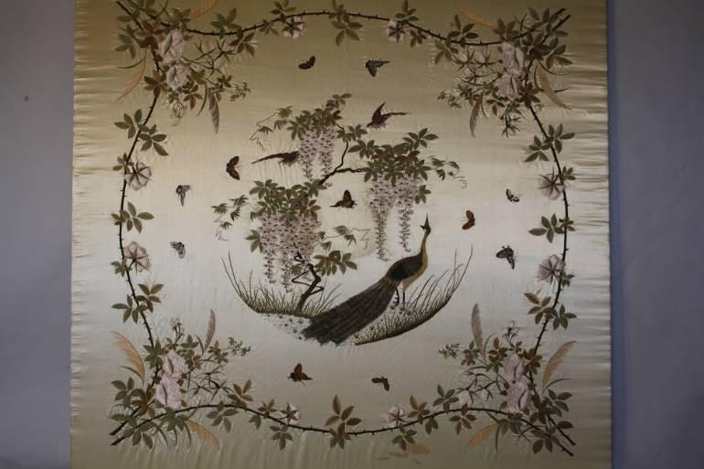 Hand embroidered Chinese textile of a peacock with butterflies, wisteria and roses. c1950