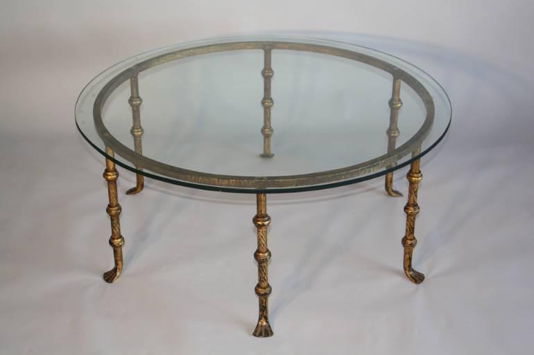 A Spanish gilt metal and glass circular coffee table. c1950