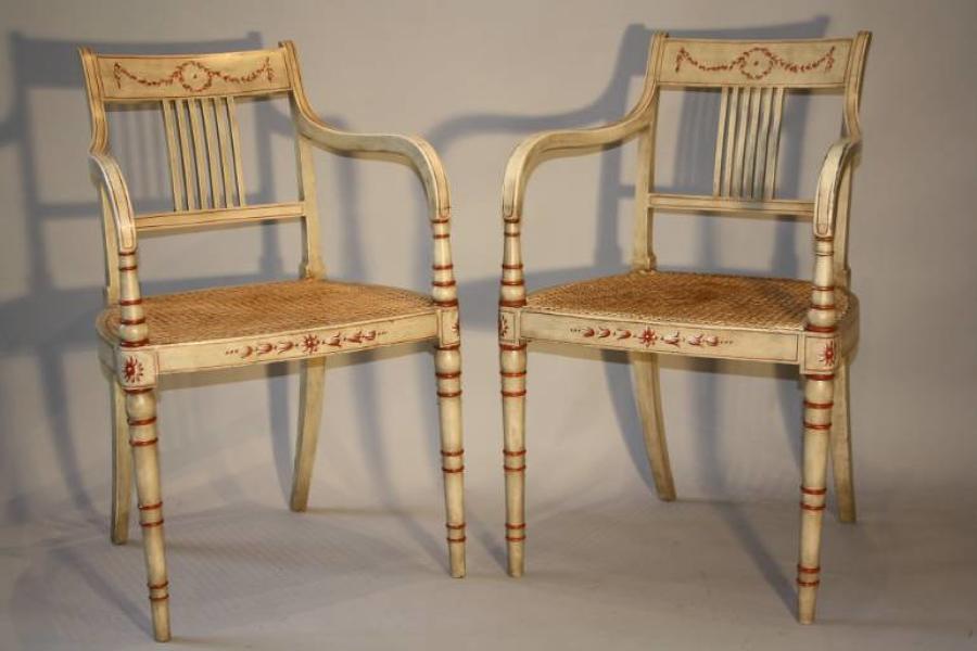 Regency style red and ivory painted open armchairs with cane seats, c1920