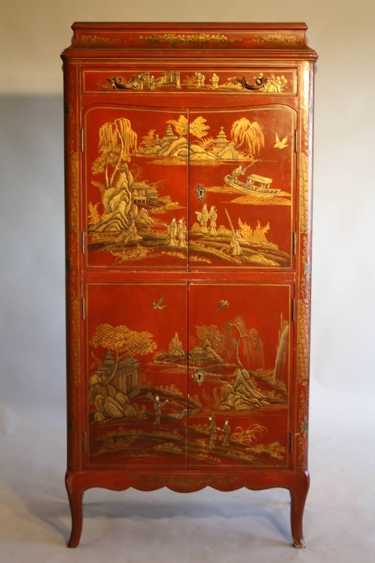 A 1920`s red chinoiserie tall cabinet