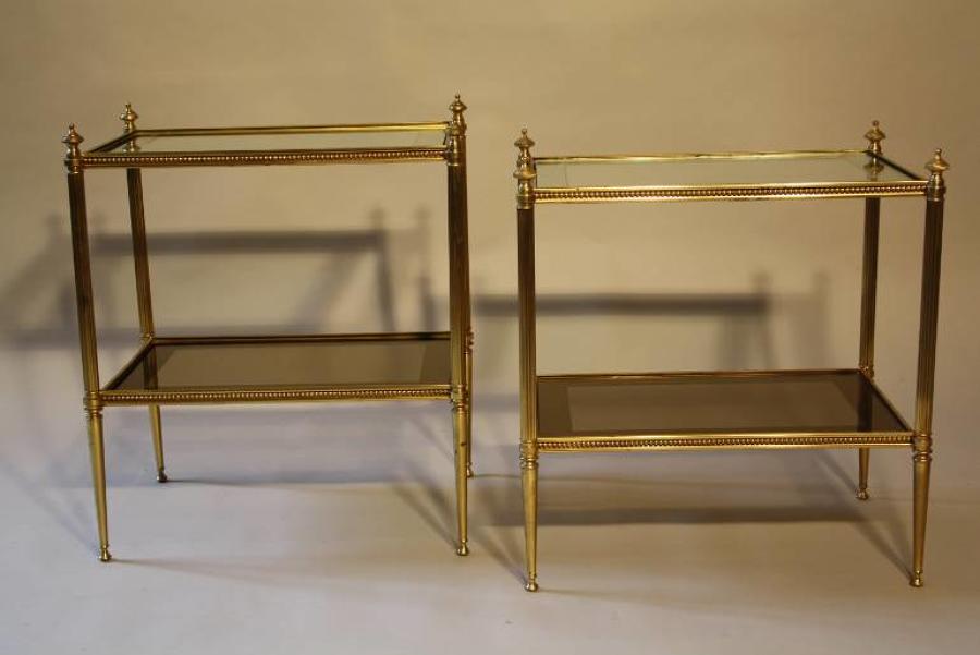A pair of brass and mirror edge two tier end tables