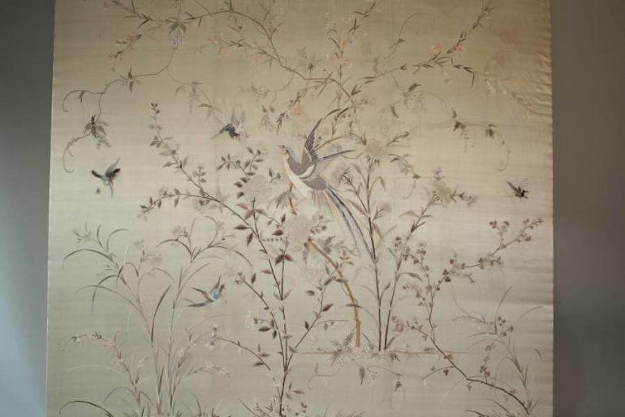 A large hand embroidered textile of birds and flowers