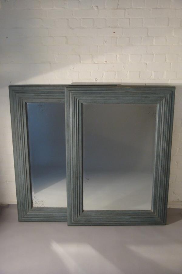 A pair of large pale blue mirrors made from 19thC architrave and fitted with antique bevelled mirror glass