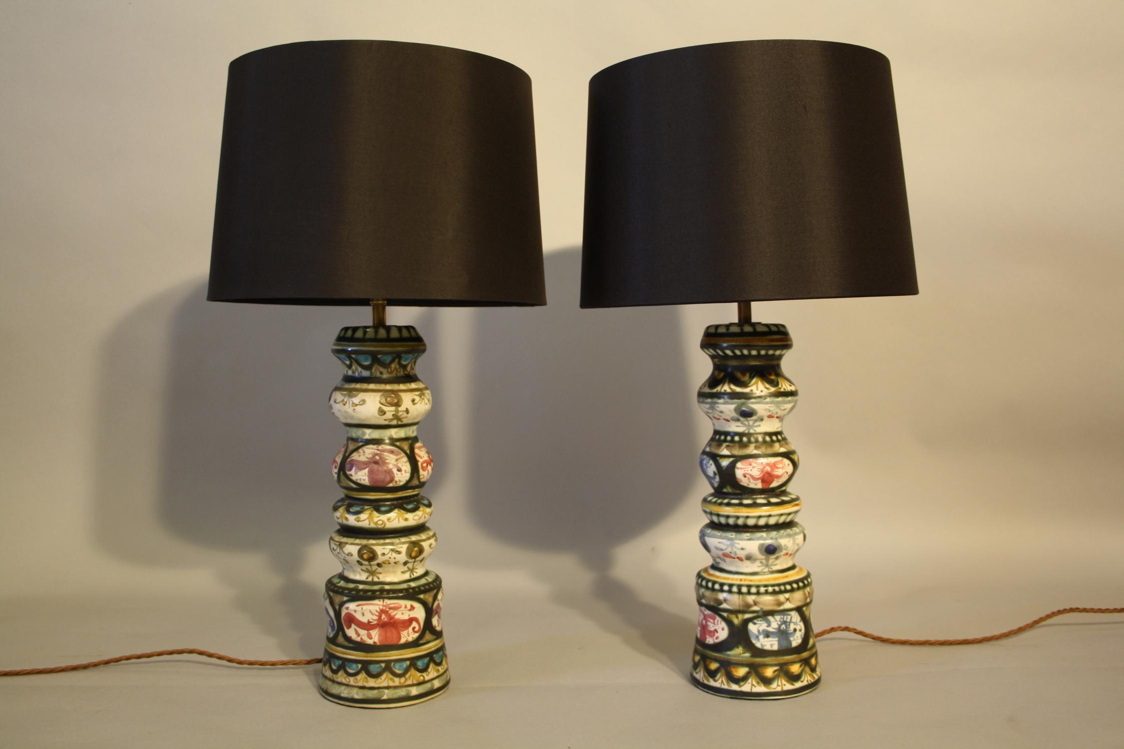 A pair of folksy painted ceramic table lamps