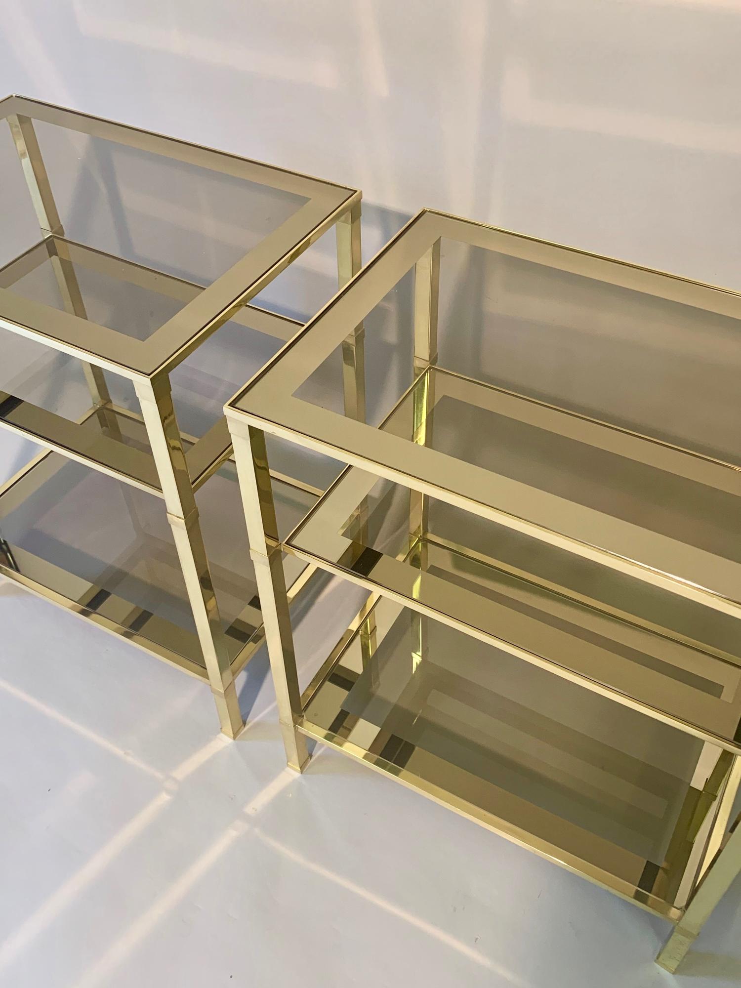 Pair of three tier brass side tables