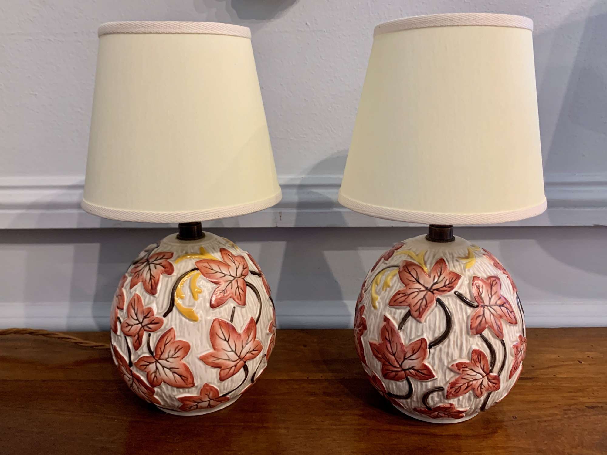 Pair of red ivy 1950's bedside ceramic lamps
