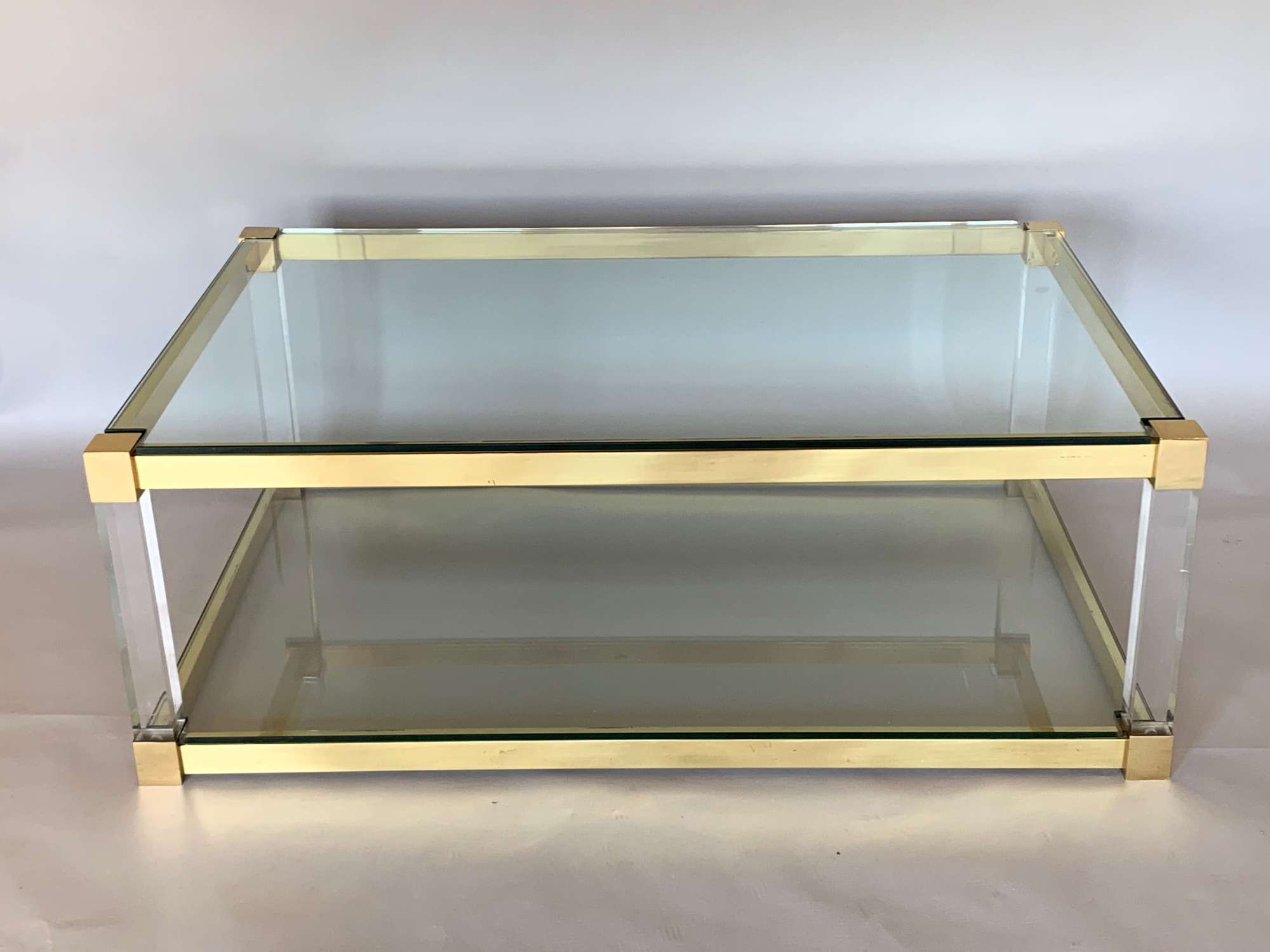 Two tier lucite and brass coffee table