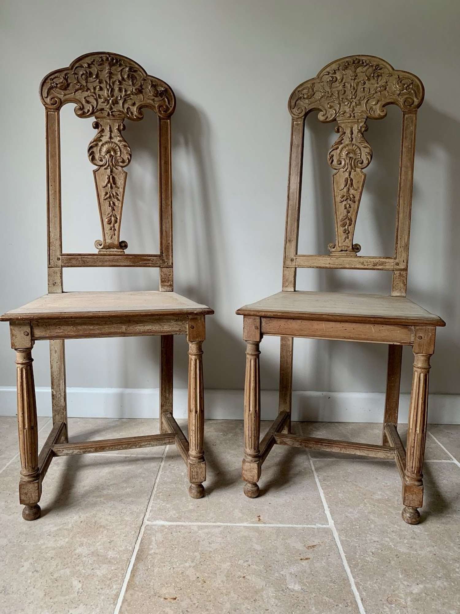 Pair of carved and limed walnut chairs