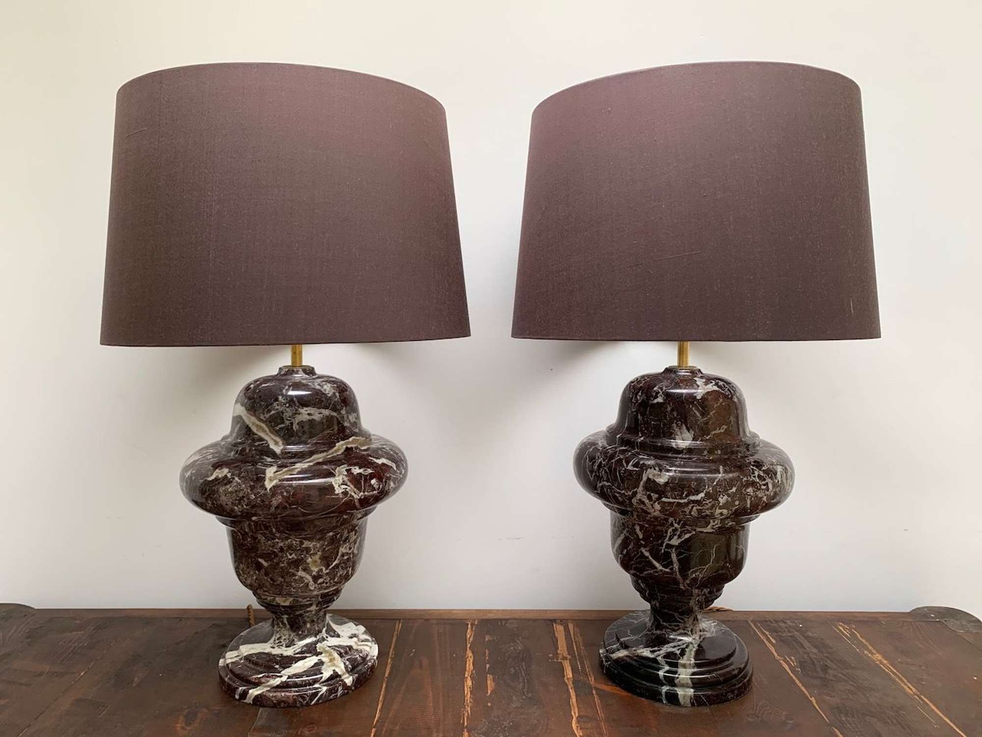 A pair of burgundy marble baluster table lamps